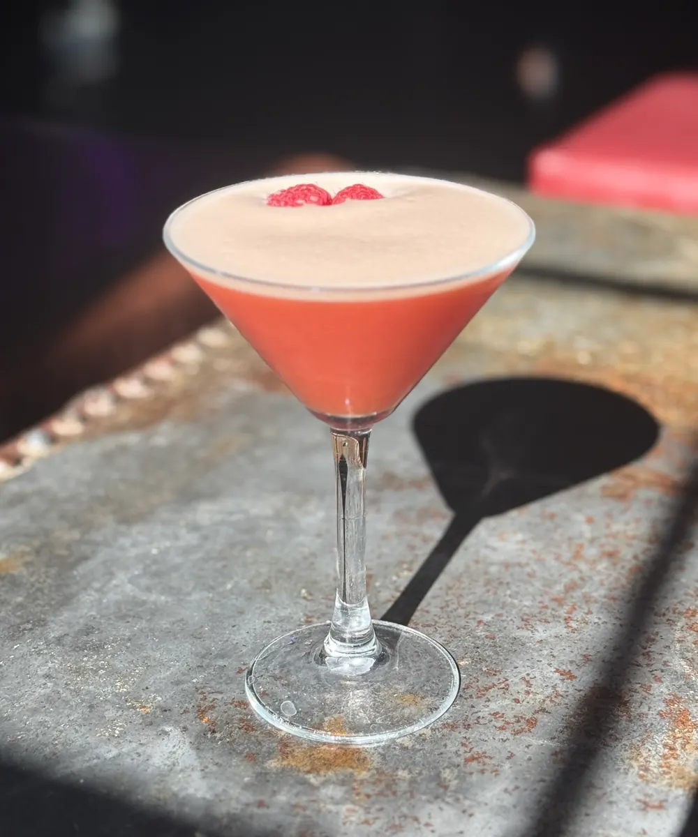 Raspberry-topped cocktail with a foam head at Fizzy Moon Brewhouse
